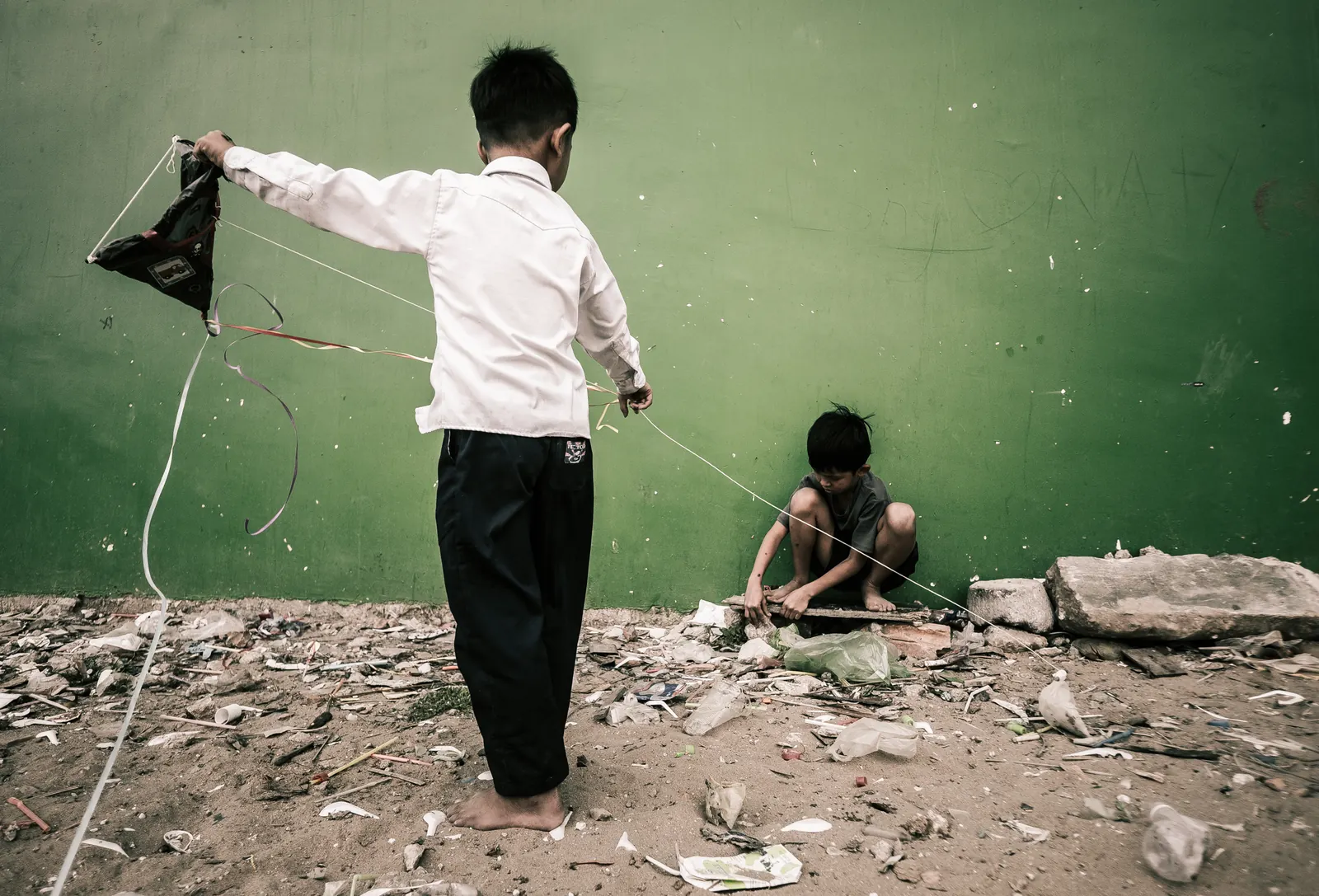A child flying a kite made from a plastic bag