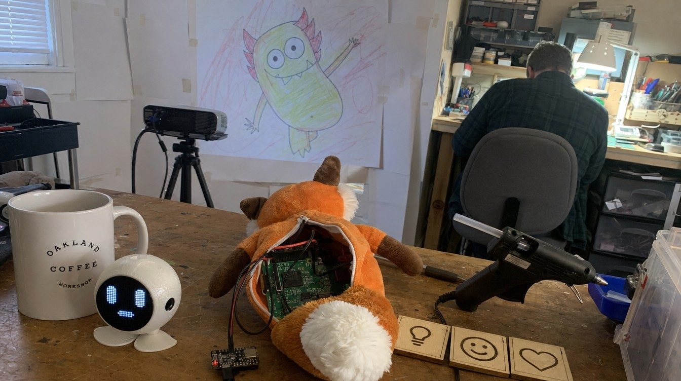 Workshop bench: opened plush fox with a Pi inside, a dome robot, wooden tiles, projector on the wall